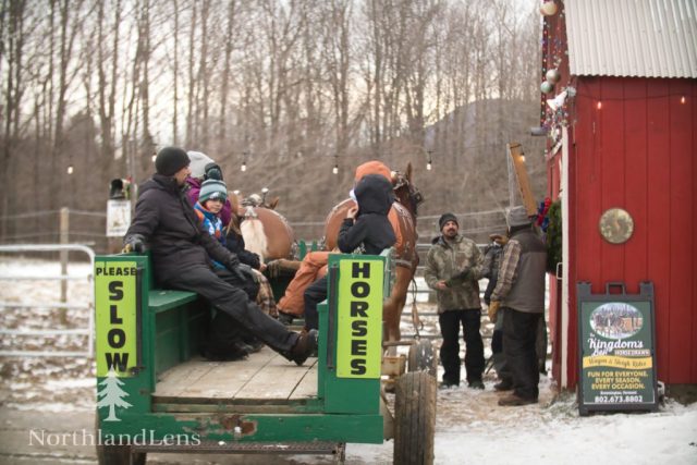 Bundled-up riders settle onto the wagon as Jeff Simpson makes final preparations before heading out for a horse-drawn ride at The Kingdom’s Horse Drawn Wagon and Sleigh Rides in Brownington. (Photo by Tim Lenahan)