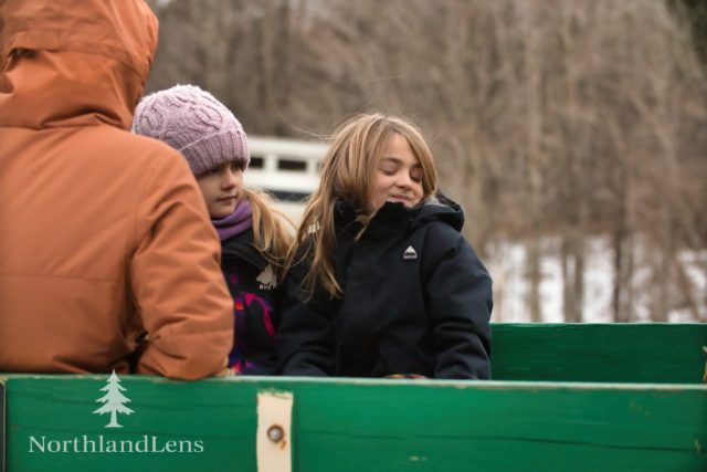 Children settle into the wagon as a wagon ride gets underway at The Kingdom’s Horse Drawn Wagon and Sleigh Rides in Brownington. (photo by Tim Lenahan)