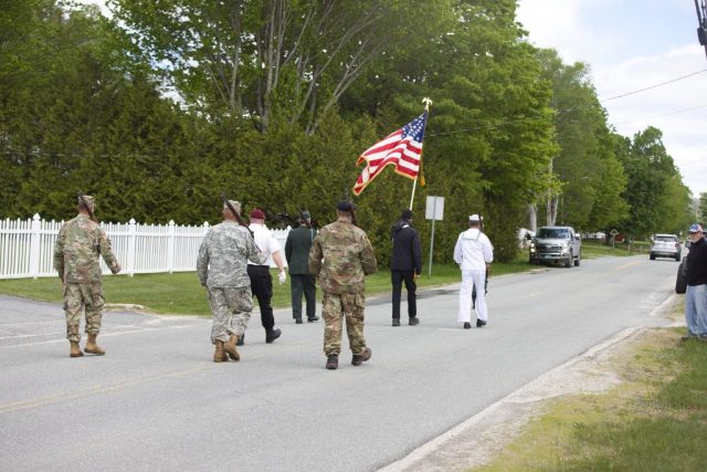 4G0A9332 An American flag is carried through downtown Island Pond during the Memorial Day parade.