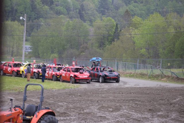 demo derby – lineup Demolition derby cars line up beside the muddy track during Memorial Day events at the Orleans County Fairgrounds in Barton, Vermont.