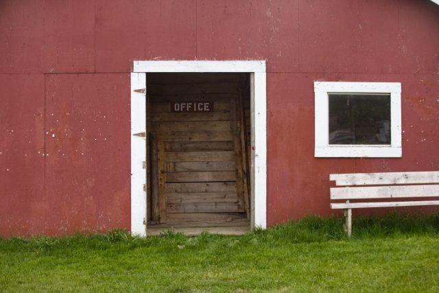 fairgrounds office door Rustic office doorway and bench against a red building at the Orleans County Fairgrounds in Barton, Vermont.