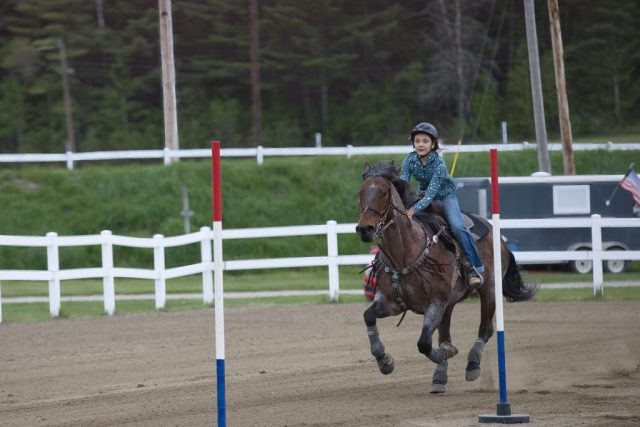 Emmah Davis guides her horse through the pole course
