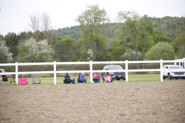 poll and barrels – spectators Spectators sit along the arena fence watching pole bending and barrel racing at the Orleans County Fairgrounds in Barton, Vermont.