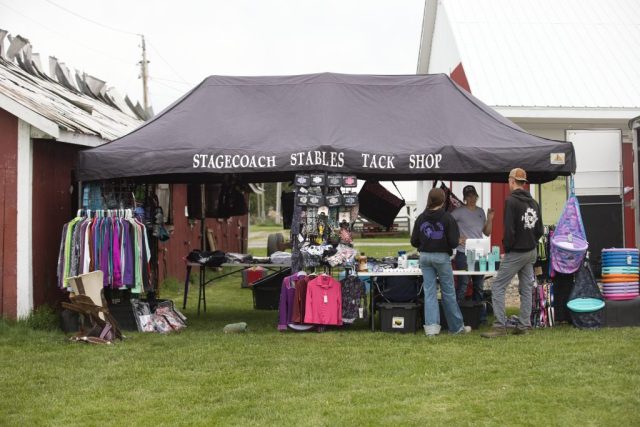 poll and barrels – tack shop Stagecoach Stables Tack Shop vendor tent displays horse tack, clothing and riding supplies at the Orleans County Fairgrounds in Barton, Vermont.