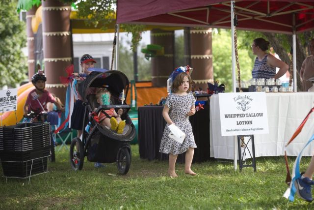 4G0A3500 Children with a patriotically decorated stroller, bicycle and accessories make their way through the children’s parade at the Danville Farmers Market in Danville, Vermont.