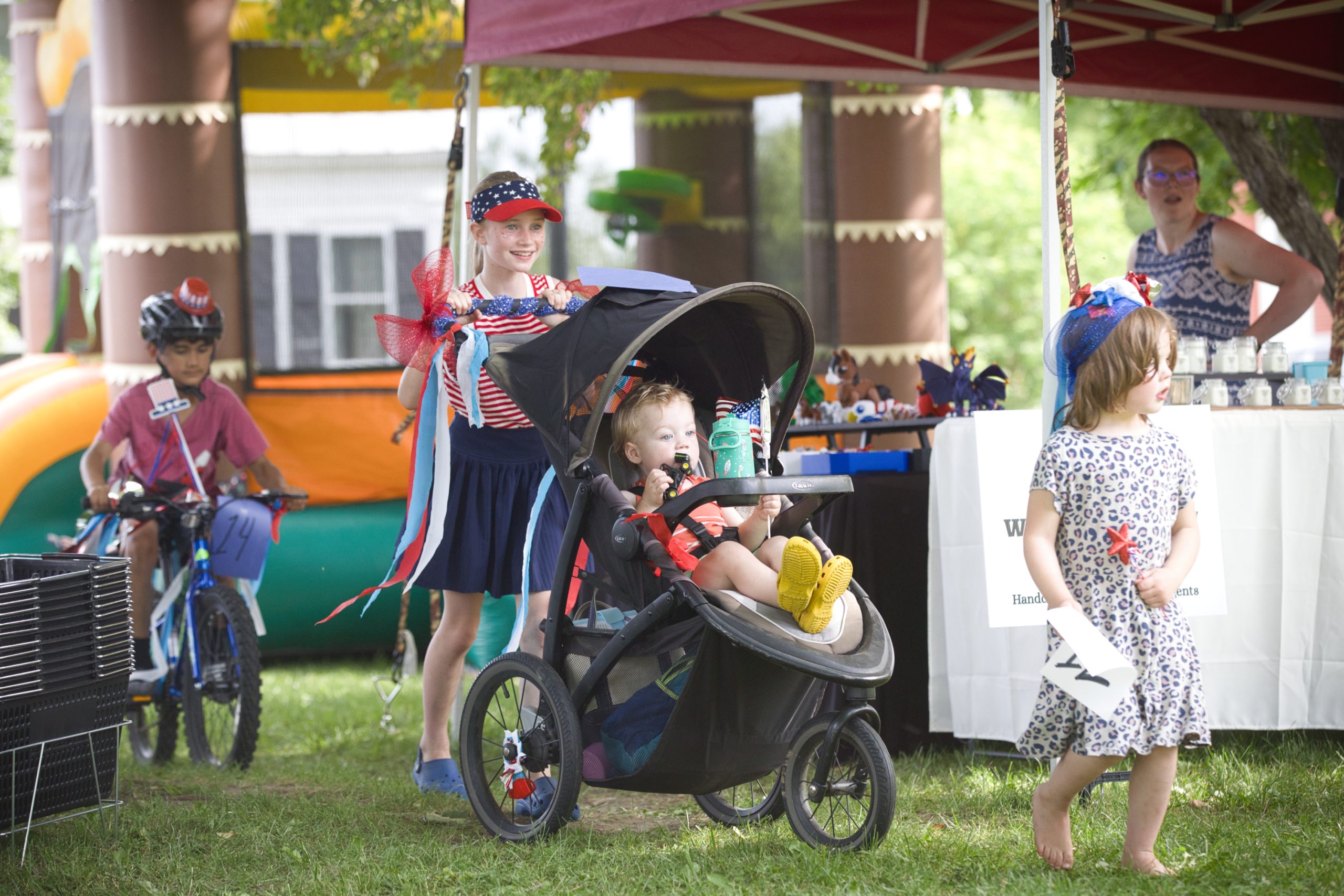 Children with patriotic decorations gather for the bicycle parade at the Danville Farmers Market’s Early Independence Day Celebration in Danville, Vermont.