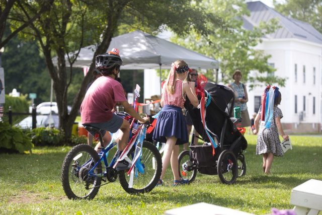 4G0A3509 Children with a decorated bicycle and stroller continue their patriotic parade across the Danville Green during the Danville Farmers Market in Danville, Vermont.